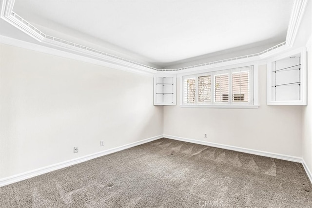 carpeted empty room featuring baseboards