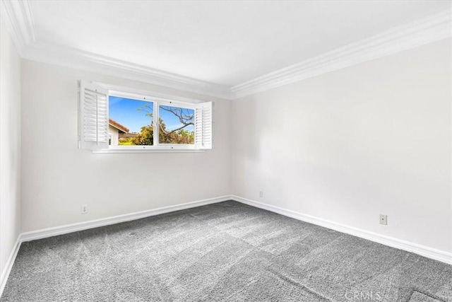 empty room with crown molding, baseboards, and carpet