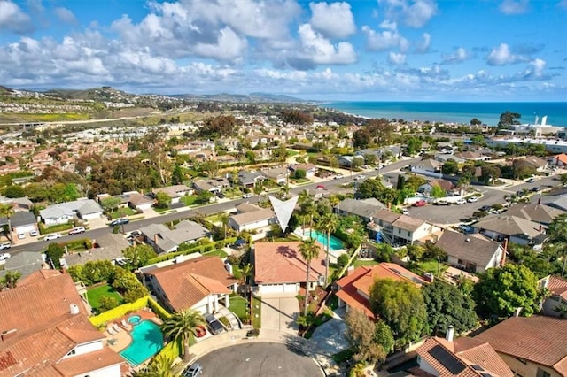 drone / aerial view featuring a water view and a residential view