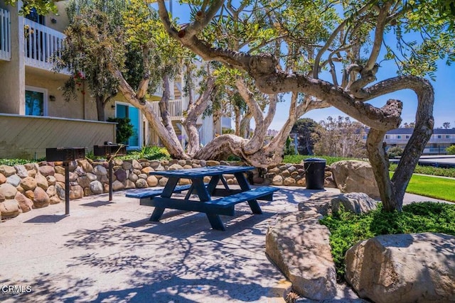 view of community with outdoor dining space and a patio area
