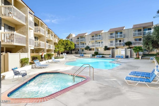 community pool featuring fence and a patio area