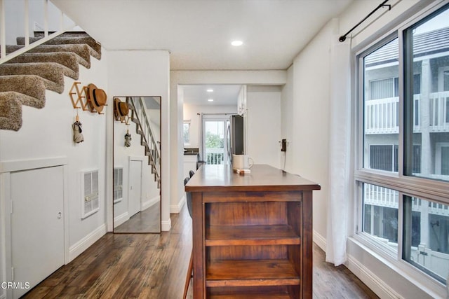 interior space with dark wood-style flooring, stairs, recessed lighting, baseboards, and freestanding refrigerator