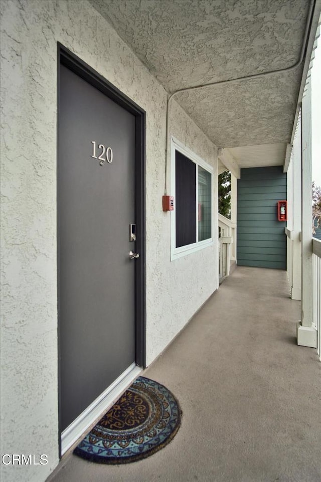 entrance to property with stucco siding