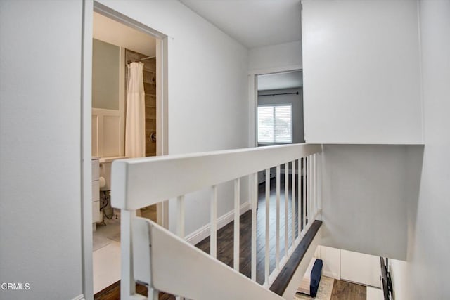 stairway with wood finished floors