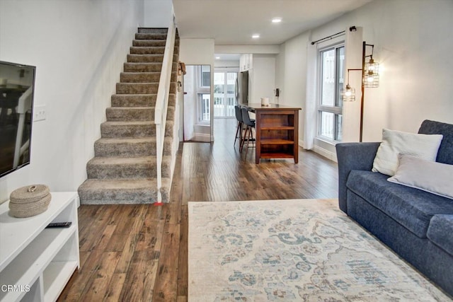 living area featuring stairway, recessed lighting, and dark wood-style flooring