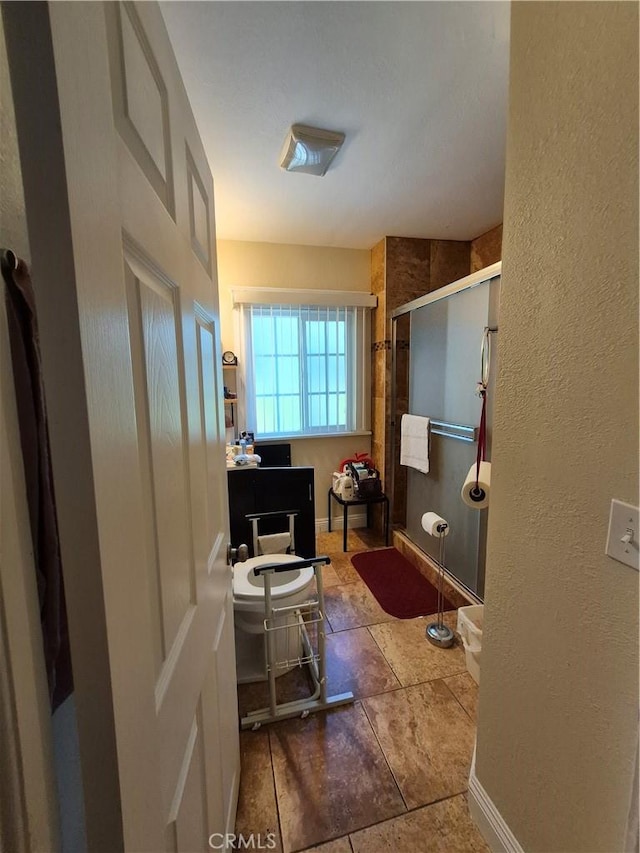 4911 S Wilton Pl, Los Angeles, CA 90062 - bathroom featuring a shower stall and a textured wall