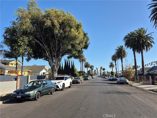 4911 S Wilton Pl, Los Angeles, CA 90062 - view of asphalt street featuring sidewalks, a residential view, and curbs