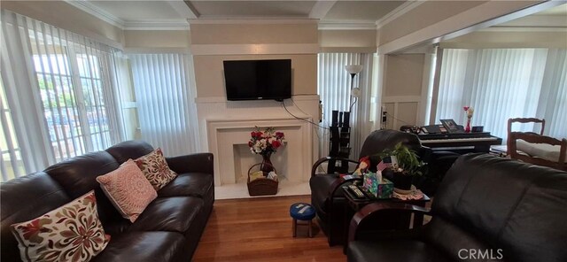 4911 S Wilton Pl, Los Angeles, CA 90062 - living area with wood finished floors, crown molding, healthy amount of natural light, and a decorative wall