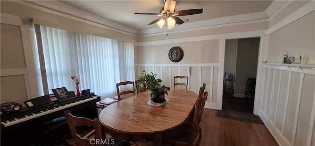 4911 S Wilton Pl, Los Angeles, CA 90062 - dining space featuring dark wood-style floors, ceiling fan, a decorative wall, and wainscoting