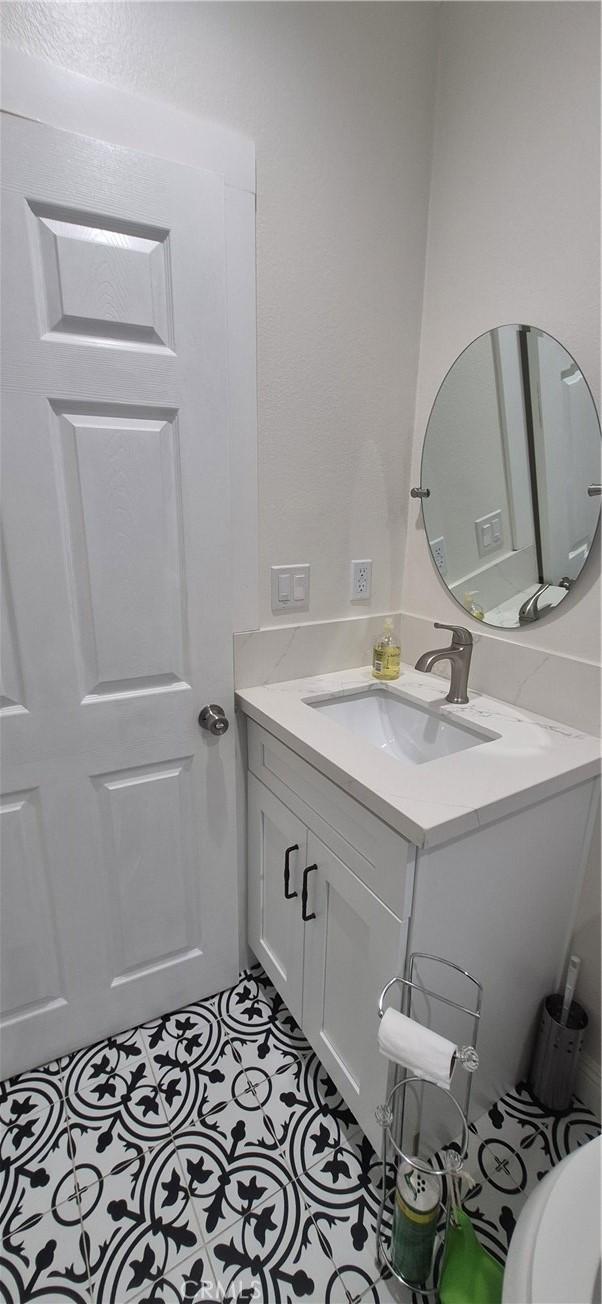 4911 S Wilton Pl, Los Angeles, CA 90062 - bathroom featuring vanity and tile patterned flooring