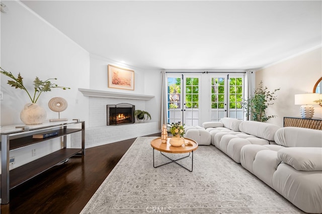 1930 S Beverly Glen Blvd Unit 103, Los Angeles, CA 90025 - living room with wood finished floors, a brick fireplace, and ornamental molding