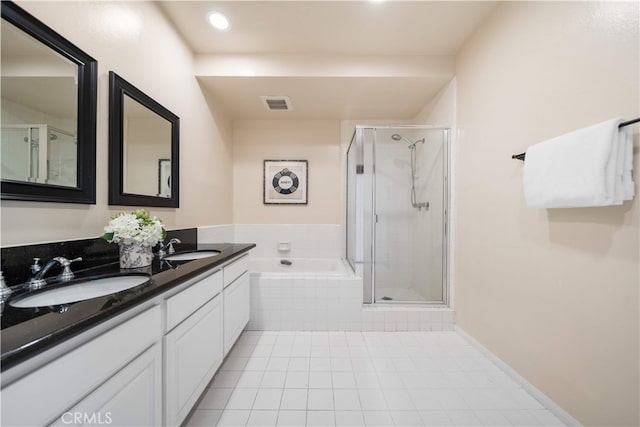 1930 S Beverly Glen Blvd Unit 103, Los Angeles, CA 90025 - bathroom with tile patterned floors, a shower stall, a garden tub, double vanity, and recessed lighting