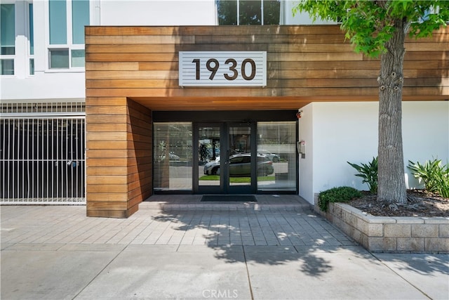 1930 S Beverly Glen Blvd Unit 103, Los Angeles, CA 90025 - view of exterior entry with french doors and stucco siding