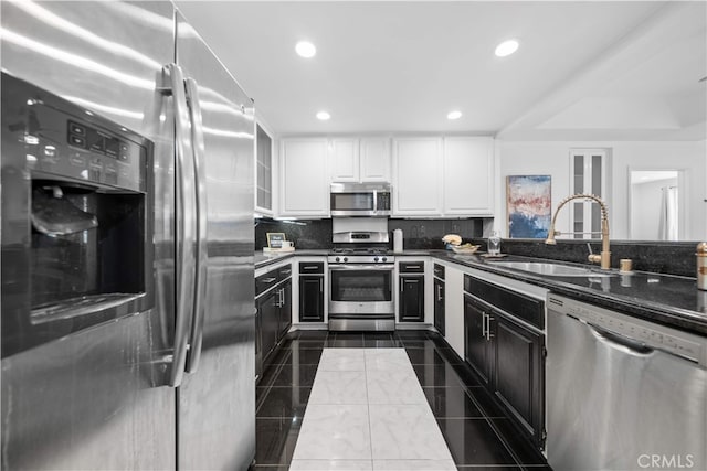 1930 S Beverly Glen Blvd Unit 103, Los Angeles, CA 90025 - kitchen with stainless steel appliances, white cabinets, a sink, recessed lighting, and dark countertops