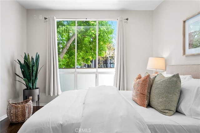 1930 S Beverly Glen Blvd Unit 103, Los Angeles, CA 90025 - bedroom featuring multiple windows, wood finished floors, and baseboards