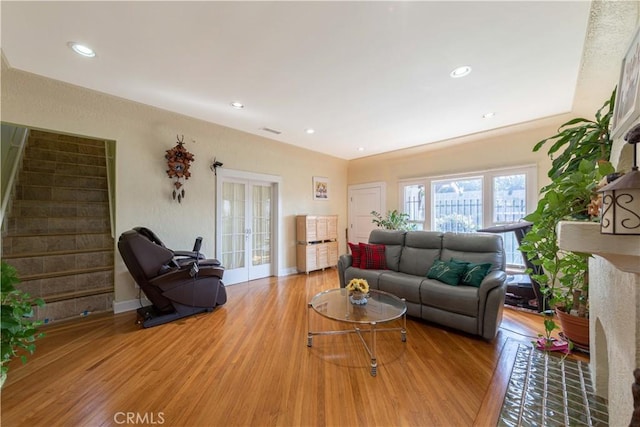 living area featuring recessed lighting, stairs, light wood-type flooring, visible vents, and french doors