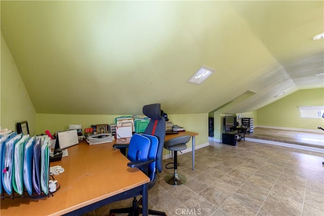 home office with vaulted ceiling and baseboards