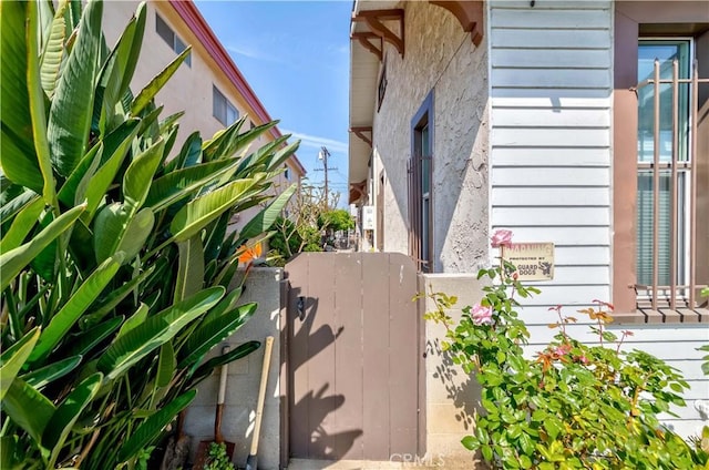 view of side of property with fence and a gate