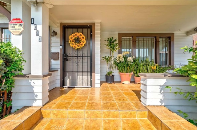 view of exterior entry with covered porch