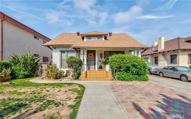 bungalow with a shingled roof