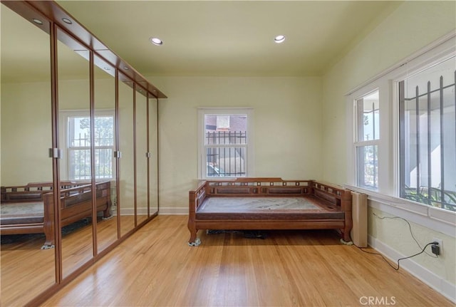 living area featuring recessed lighting, wood finished floors, and baseboards