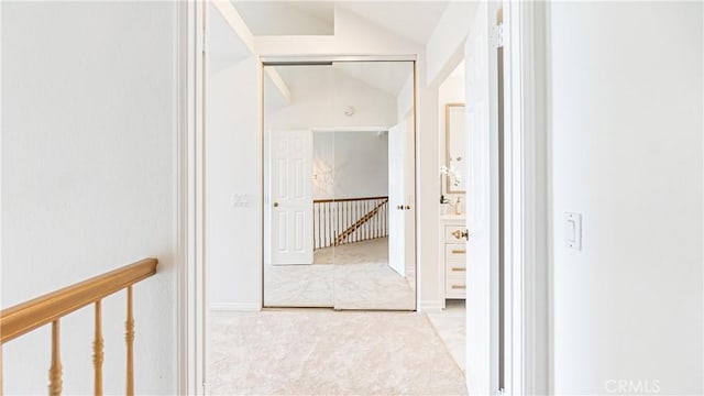 corridor with carpet and lofted ceiling