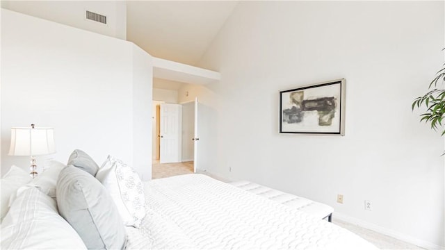 bedroom featuring visible vents, baseboards, carpet floors, and lofted ceiling