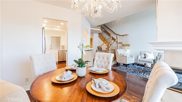 dining area featuring stairs, recessed lighting, baseboards, and a notable chandelier