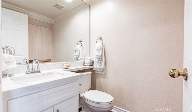 bathroom featuring visible vents, ornamental molding, a textured wall, vanity, and toilet