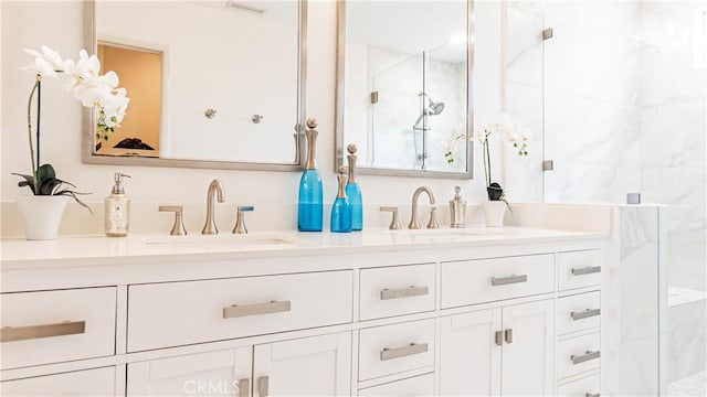 full bathroom with a sink, double vanity, and tiled shower