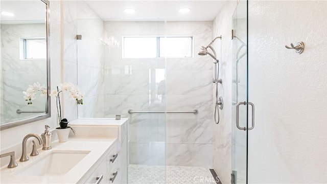 bathroom featuring vanity and a shower stall