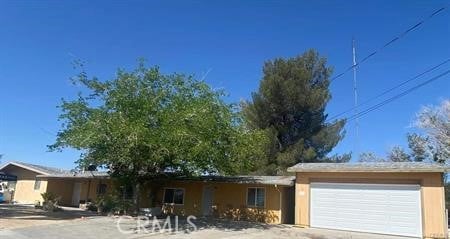 8782 Peach Ave, Hesperia, CA 92345 - ranch-style home featuring a garage and stucco siding