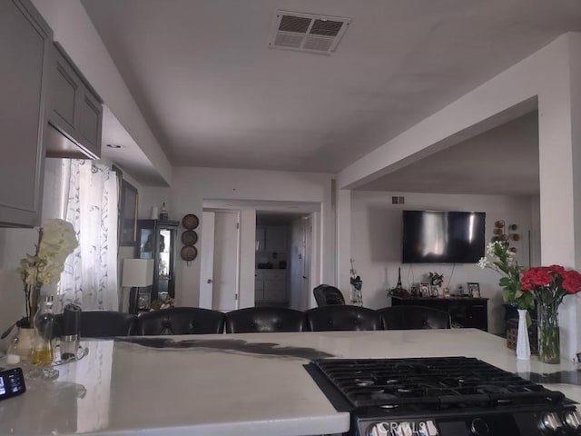 8782 Peach Ave, Hesperia, CA 92345 - kitchen featuring open floor plan, range with gas cooktop, and light countertops