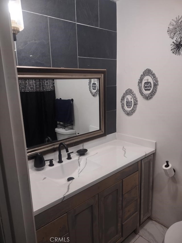8782 Peach Ave, Hesperia, CA 92345 - half bathroom featuring toilet, vanity, and marble finish floors