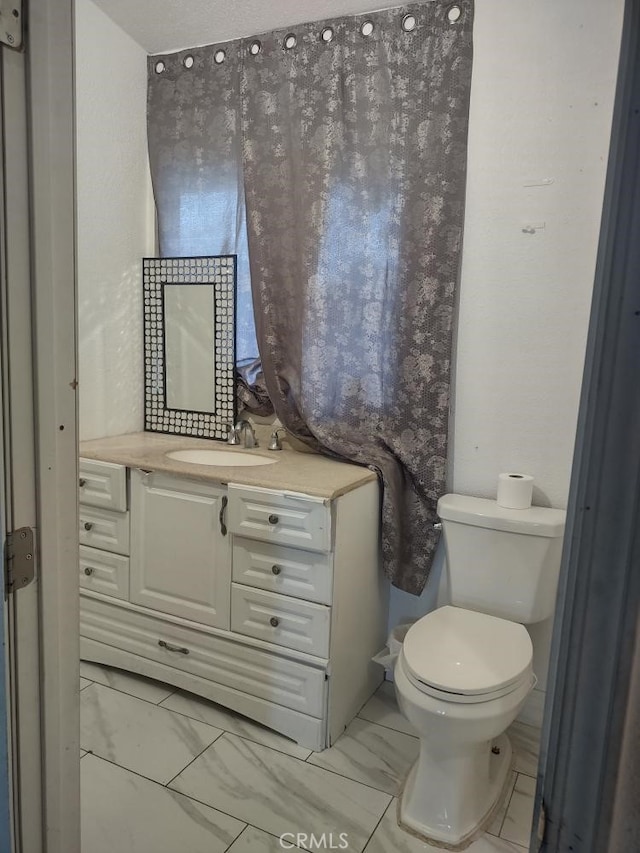 8782 Peach Ave, Hesperia, CA 92345 - half bathroom featuring marble finish flooring, toilet, and vanity