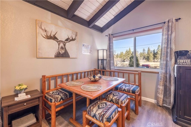 dining room with baseboards, vaulted ceiling with beams, wood finished floors, and wood ceiling