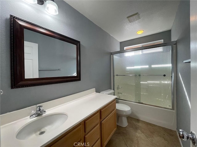 31556 Umbria Ln, Winchester, CA 92596 - full bathroom featuring vanity, combined bath / shower with glass door, a textured ceiling, and tile patterned floors