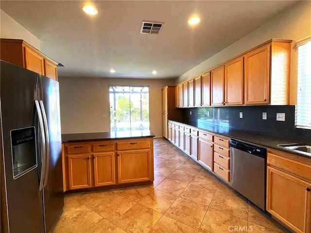 31556 Umbria Ln, Winchester, CA 92596 - kitchen with stainless steel appliances, dark countertops, recessed lighting, a peninsula, and brown cabinetry