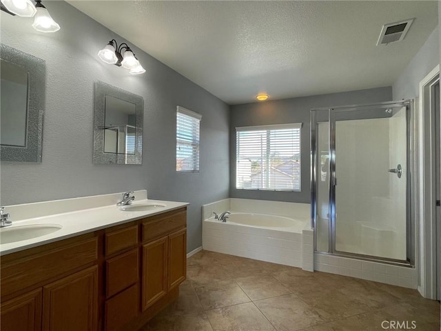31556 Umbria Ln, Winchester, CA 92596 - full bathroom with a garden tub, double vanity, a shower stall, tile patterned flooring, and a textured ceiling
