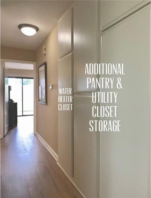 hallway with baseboards and wood finished floors