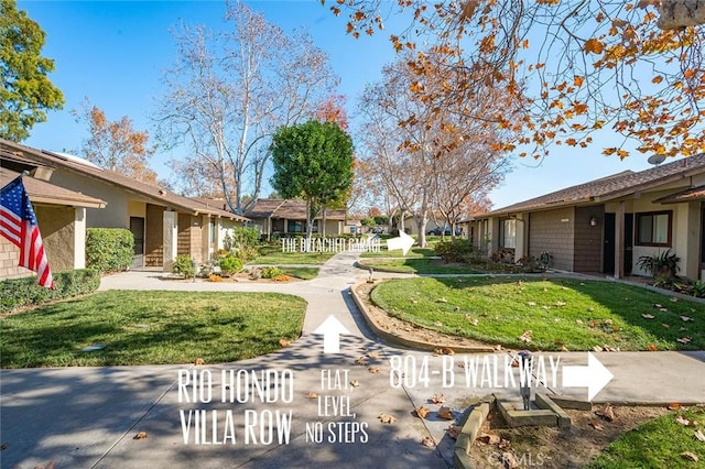 view of property's community with a lawn