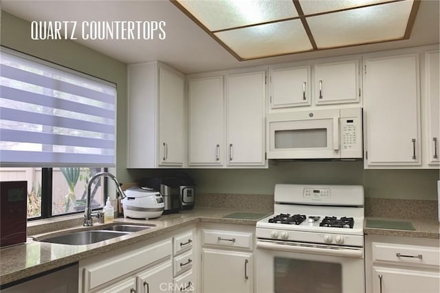 kitchen featuring a sink, white cabinets, and white appliances