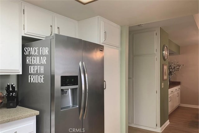 kitchen with white cabinets, stainless steel refrigerator with ice dispenser, baseboards, and wood finished floors