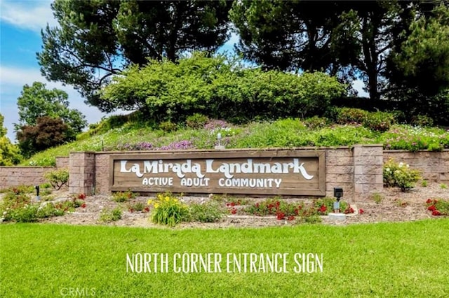 community / neighborhood sign with a lawn