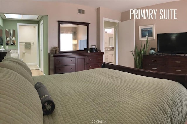 bedroom with visible vents and connected bathroom