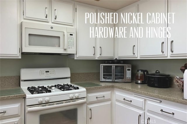 kitchen featuring a toaster, white cabinets, and white appliances