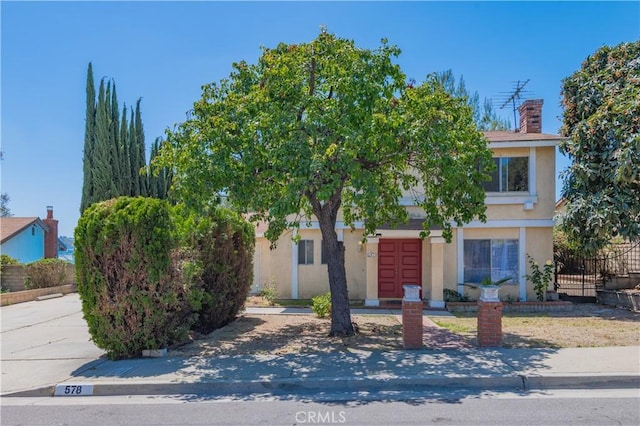 578 Vista Rambla, Walnut, CA 91789 - obstructed view of property featuring stucco siding, a chimney, and fence
