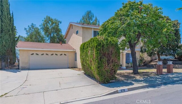578 Vista Rambla, Walnut, CA 91789 - obstructed view of property featuring stucco siding, driveway, and a garage