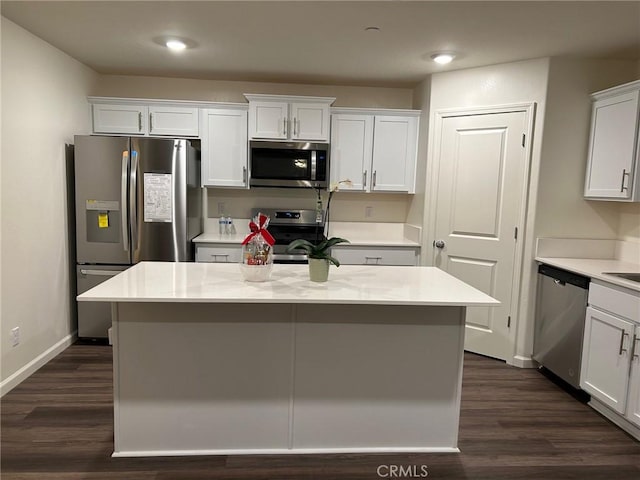 kitchen with light countertops, baseboards, white cabinets, and stainless steel appliances