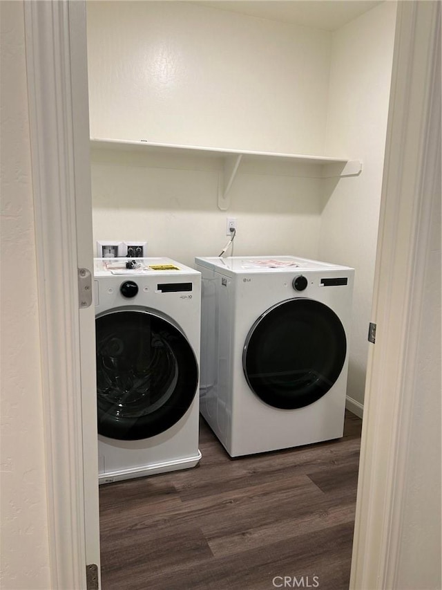 laundry area with separate washer and dryer, laundry area, and dark wood-type flooring